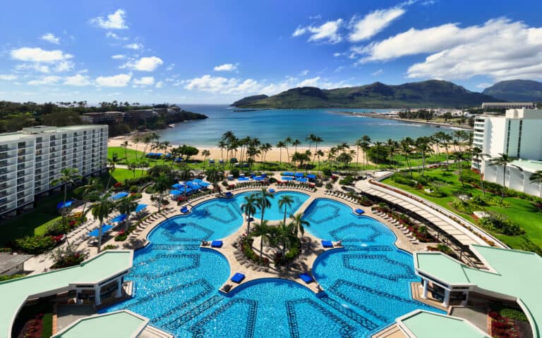 A panoramic view from The Royal Sonesta Kauai resort, showcasing the skyline and surrounding landscape under a clear blue sky.